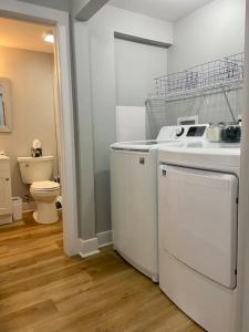 a laundry room with a washer and dryer and a toilet at SJ Suburban HiDeAwAy 