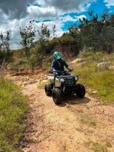 a person riding a four wheeler on a dirt road at Dante Glamping in Guatavita