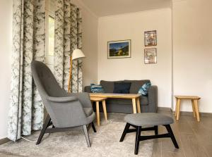 a living room with a table and a chair at Aegean breeze apartment in Karpathos