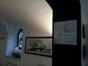 a hallway with two pictures of a boat on the wall at Hotel Argentina in Santa Margherita Ligure