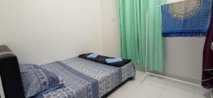 a small bedroom with a bed and a window at NVACASTAY in Marang