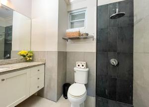 a bathroom with a toilet and a shower at Choose To Be Happy at EI8HT! - Super Studios and Penthouse Apartment in Kingston