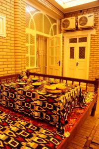 a room with a table with a blanket on it at Timur The Great in Samarkand