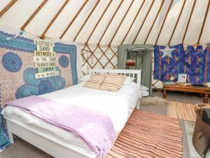 a bedroom with a white bed in a yurt at Stardust in Ventnor