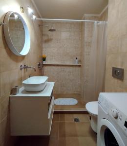 a bathroom with a sink and a shower and a toilet at Chatzidakis Apartment/Inspiration harmony in Lygaria