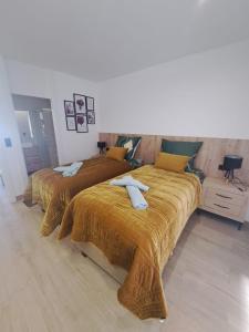 two beds in a hotel room with towels on them at Luxury Apartment La Mata right by the sea in La Mata