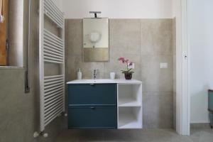 a bathroom with a blue cabinet and a sink at Al Borghetto in Piazza Armerina +76 photos