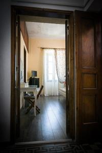 a room with a table and a desk with a window at Nymph in Sálakos