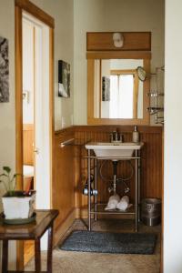 a bathroom with a sink and a mirror at Volcano Union Inn and Pub in Volcano