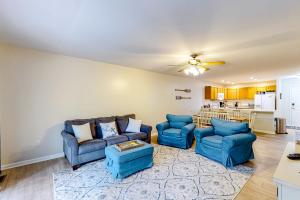 a living room with two blue couches and a kitchen at Lake Bliss in Mineral
