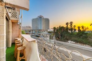 a balcony with chairs and a view of a street at The gaudi house TLV in Tel Aviv