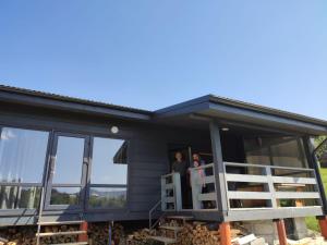 two people standing on the porch of a house at Hotel Osher in Bukovel