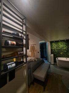 a bedroom with a bed and a tub and a sink at Casa Container - Haupt Village in Farroupilha