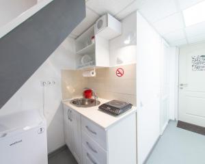 a small kitchen with white cabinets and a sink at "Ваша Квартира" - у самого Дерибаса! "Ваша Квартира" біля самого Дерибаса! in Odesa