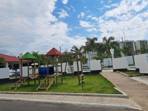 a park with a playground with a swing set at Condominio Balcones del country in Flandes