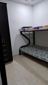 a room with two bunk beds and a cabinet at Condominio Balcones del country in Flandes