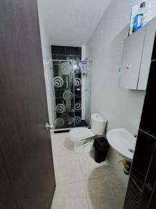 a bathroom with a shower and a toilet and a sink at Condominio Balcones del country in Flandes