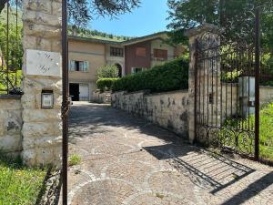 an entrance to a house with a gate and a driveway at VILLA OLGA in Cese