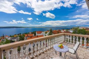 a balcony with a table and chairs and a view of the water at Studio Crikvenica 6 in Dramalj