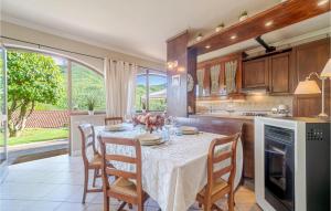 a dining room with a table and chairs and a kitchen at Casa La Selva in Cavizzano