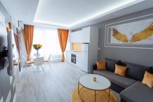 a living room with a couch and a table at GoldenLux Apartments in Oradea