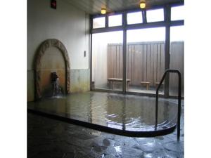 una piscina d'acqua in una stanza con finestra di Ikaho Onsen Sanyo Hotel - Vacation STAY 26406v a Shibukawa