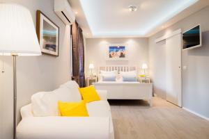 a bedroom with a white bed and yellow pillows at Serenity Split Apartments in Split