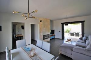 a living room with a couch and a table at Casa moderna a 300 metros de la playa. in Sant Josep de Sa Talaia