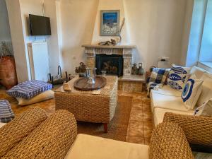 a living room with couches and a fireplace at Archontikon 1800 in Poros