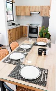 a kitchen with a table with white plates on it at Casa La Merced in Tarapoto