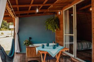 a table with blue cups on it on a patio at Recanto do Vale in Pomerode