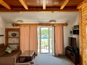 a living room with a couch and a sliding glass door at Apartmani Luka in Korčula