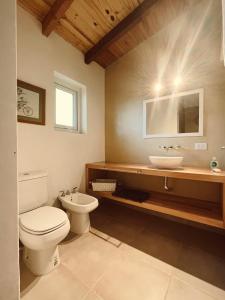 a bathroom with a toilet and a sink at Casa de Campo La Chacra in San Carlos de Bariloche