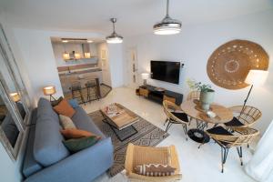 een woonkamer met een blauwe bank en een tafel bij Balcón de Marina del Este in La Herradura