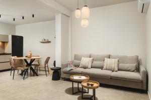 a living room with a couch and a table at Limani elegant apartments in Souda