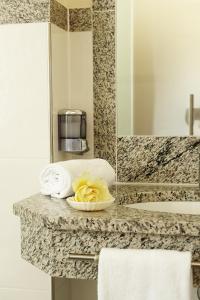 a bathroom with a counter with towels and a sink at Villa Ceconi by Das Grüne Hotel zur Post - 100% BIO in Salzburg