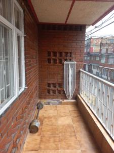 a balcony with a heater and a brick wall at Victoria brand 2 in Bogotá