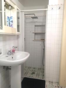 a white bathroom with a sink and a shower at Al Limone in Lipari