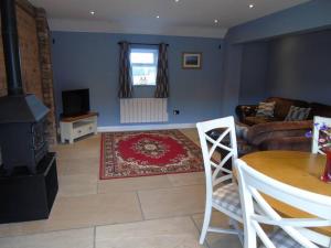 a living room with a couch and a table at The Retreat in York