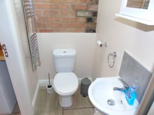 a small bathroom with a toilet and a sink at The Retreat in York