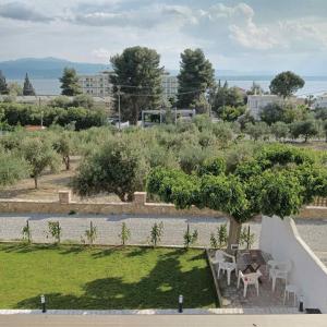 a garden with a table and chairs and trees at Villa Ioulia Malakonda, Eretria ,Greece in Eretria