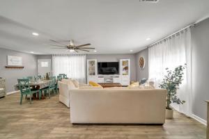 a living room with a couch and a dining room at Magnolia House - Grill Corn hole 3m to Beach in Fort Walton Beach