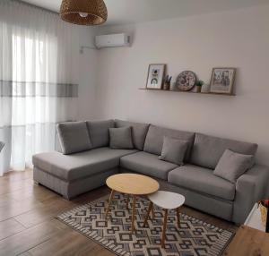 a living room with a couch and a table at Saeri's Stylish Apartment in Shëngjin