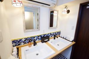 a bathroom with a sink and a mirror at Hotel Sanriiott Kitahama - Vacation STAY 33498v in Osaka