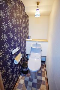 a bathroom with a toilet with snowflake wallpaper at Hotel Sanriiott Kitahama - Vacation STAY 33498v in Osaka