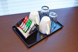 a table with a tray with a candle and glasses at Hotel Sanriiott Kitahama - Vacation STAY 33596v in Osaka +2 photos