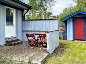 a wooden deck with a table and chairs on a house at 8 person holiday home in Mönsterås-By Traum in Mönsterås
