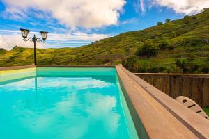 a swimming pool with a view of a mountain at Las Cuevitas del Gamonal in Santa Brígida