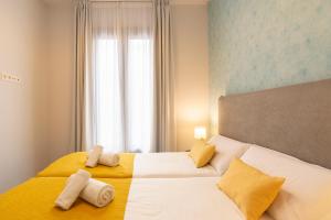 A bed or beds in a room at Malaga a Tu Ritmo! Edificio muy tranquilo y moderno!