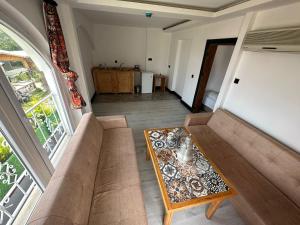 a living room with a couch and a table at White Country Boutique Hotel in Antalya